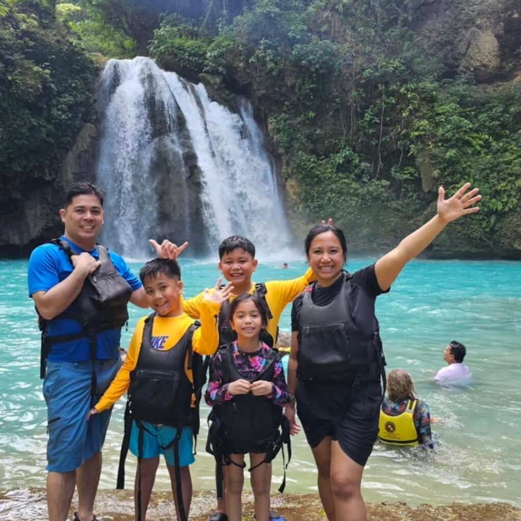 Family at Kawasan Falls After Canyoneering A family posing at Kawasan Falls after the Kawasan Canyoneering adventure in Badian, Cebu.
